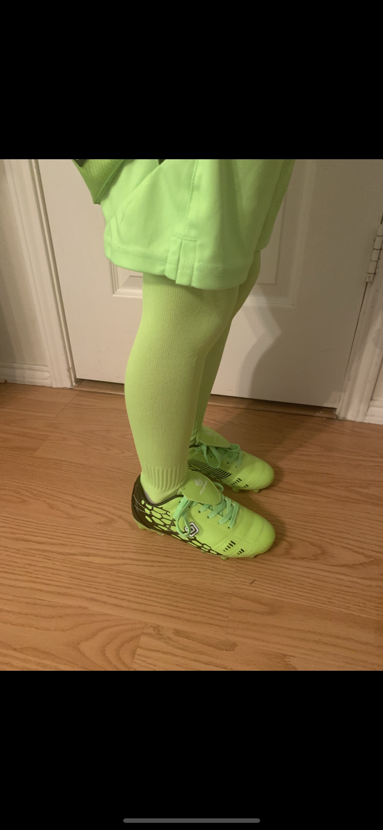 Side view of DREAM PAIRS cleats showing profile and stud pattern design