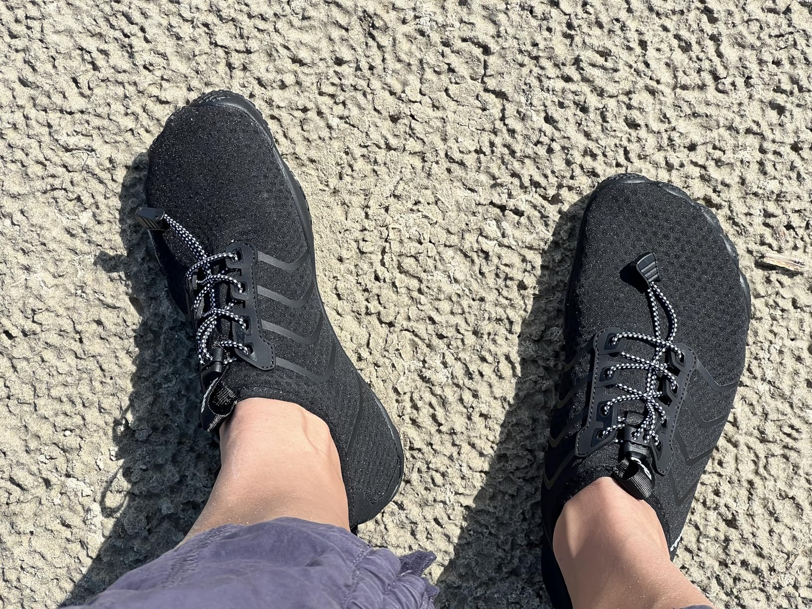 Racqua water shoes black colorway showing barefoot design and quick-dry mesh upper