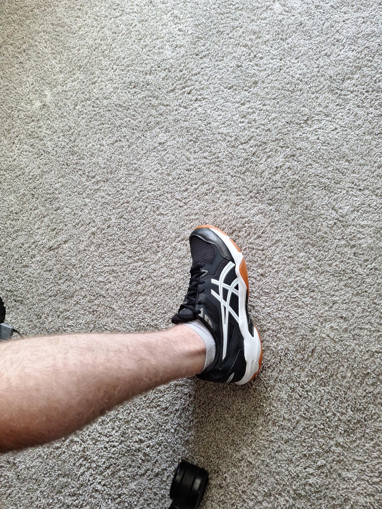 ASICS Gel-Rocket 10 action shot showing lateral support and court traction during sports movement
