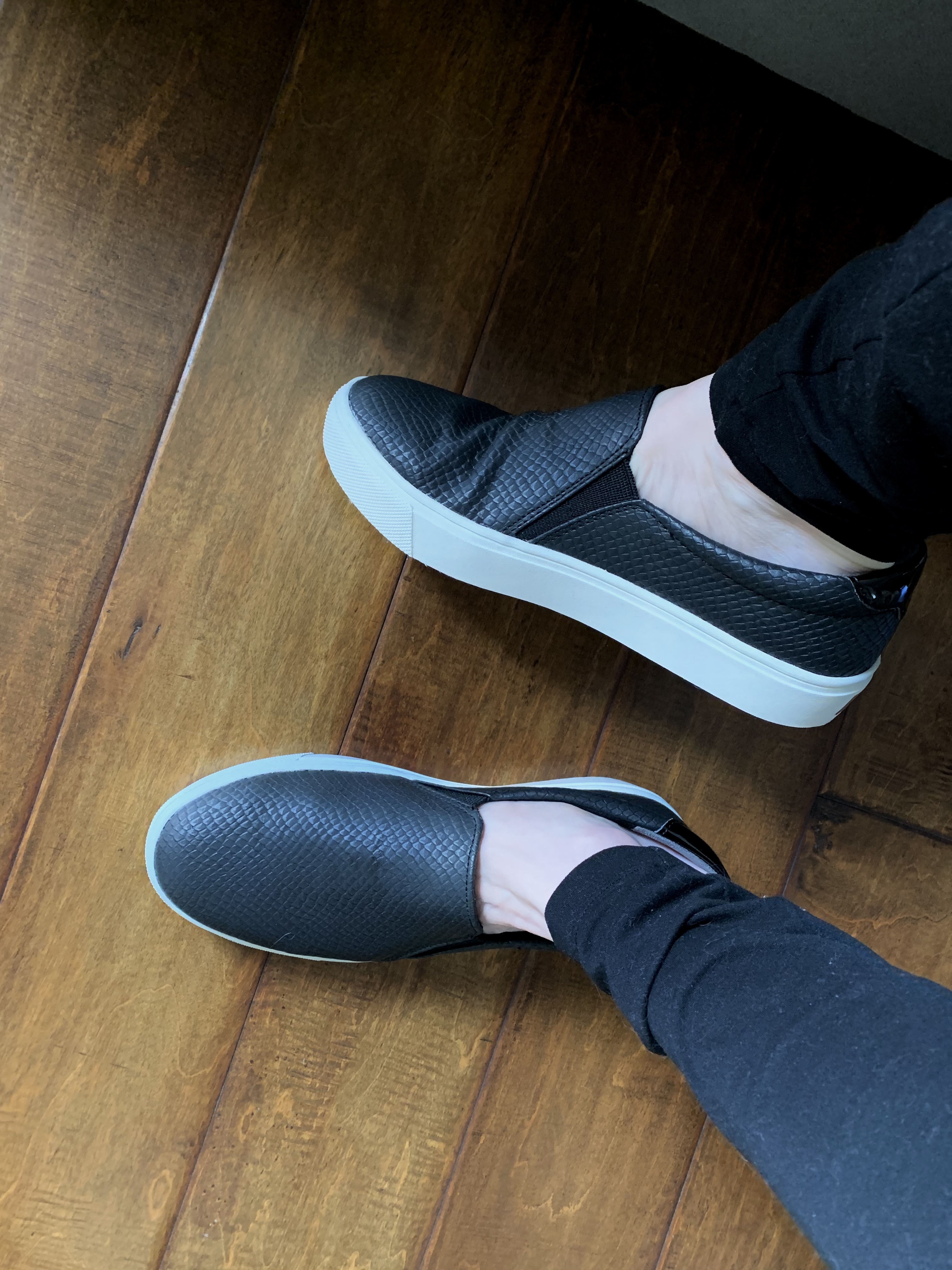 Dr. Scholl's Nova slip-on sneakers showing clean black design and platform sole construction
