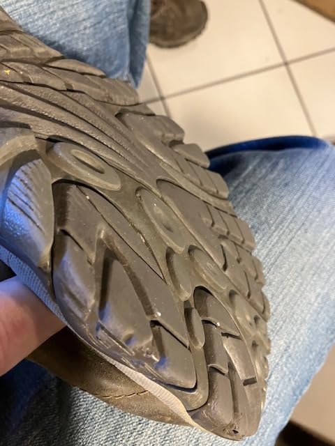 Close-up view of Merrell Adventure Lace showing leather construction and lacing system detail