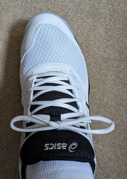 Bottom view of ASICS Upcourt 5 gum rubber outsole showing traction pattern for court sports