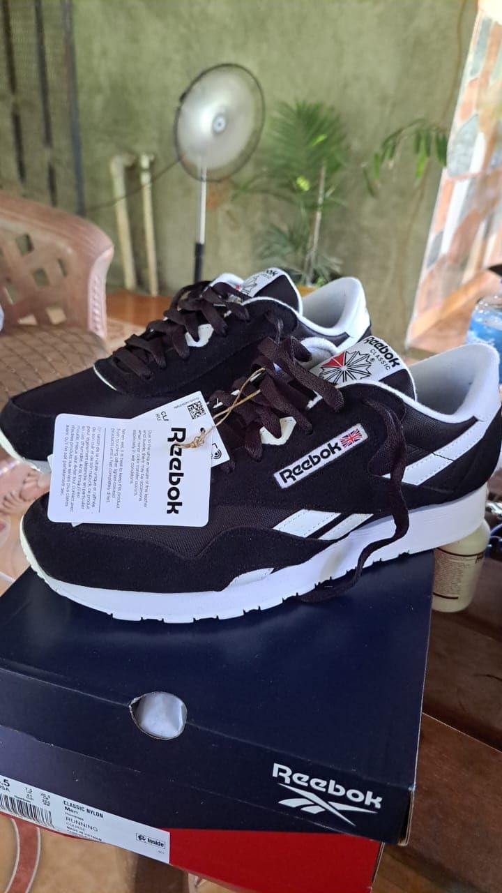 Close-up view of Reebok Classic sneaker toe box and lacing system showing nylon and synthetic leather construction