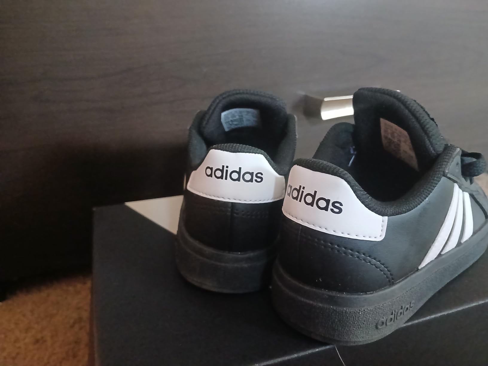 Close-up detail of Adidas Grand Court 2.0 kids sneaker showing synthetic leather upper and construction quality