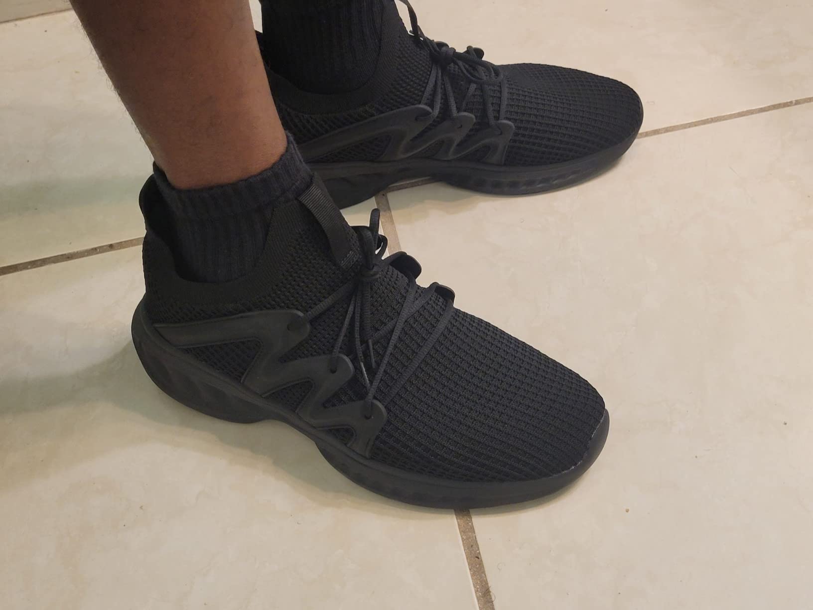 Close-up view of Pujcs walking shoes mesh upper construction and lacing system