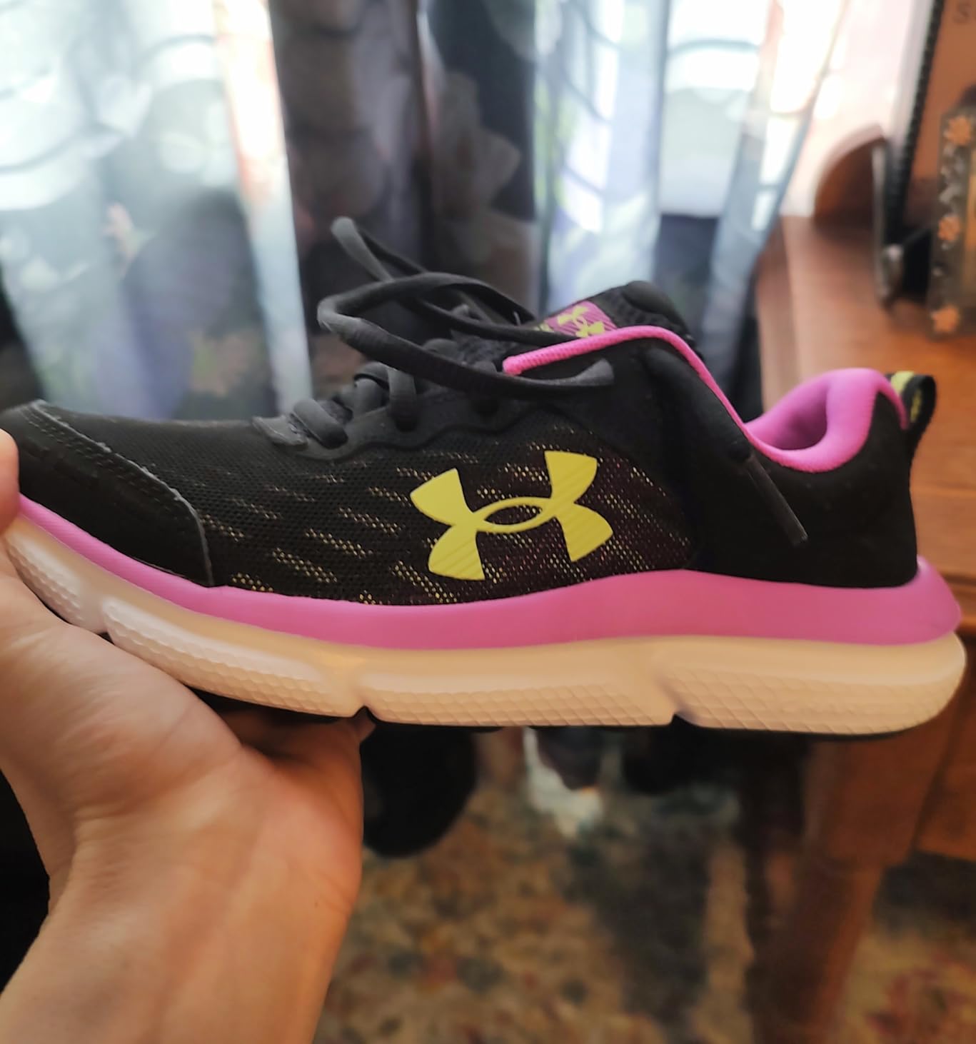 Under Armour Assert 10 kids sneakers showing mesh upper and EVA midsole construction