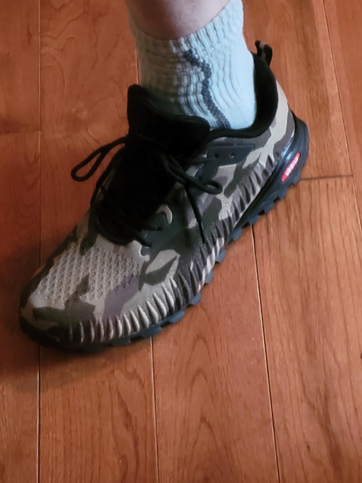 Detailed view of X-GRIP rubber sole pattern and aggressive tread design for traction