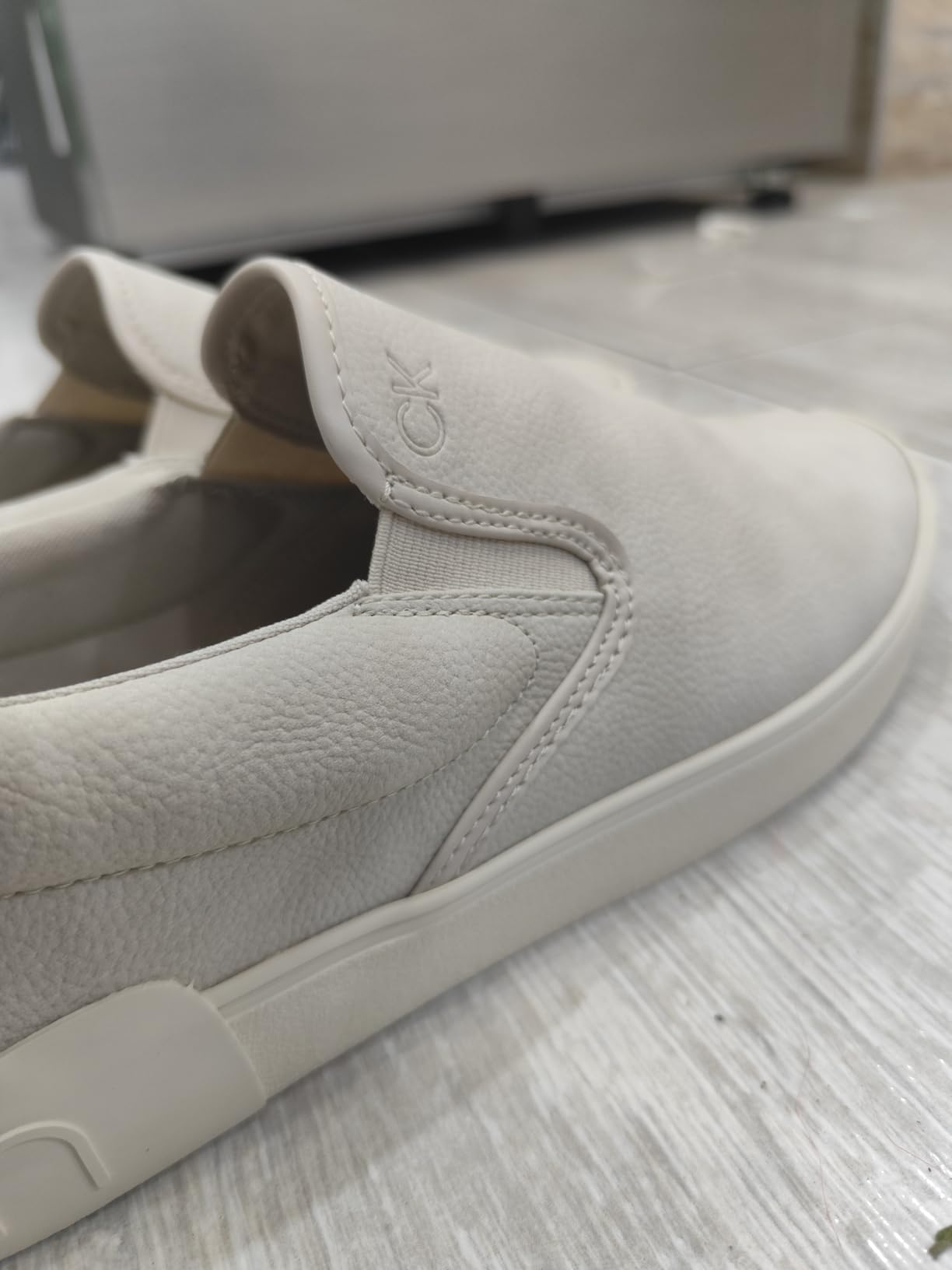Close-up view of Calvin Klein Ryor sneaker heel showing CK logo detail and construction