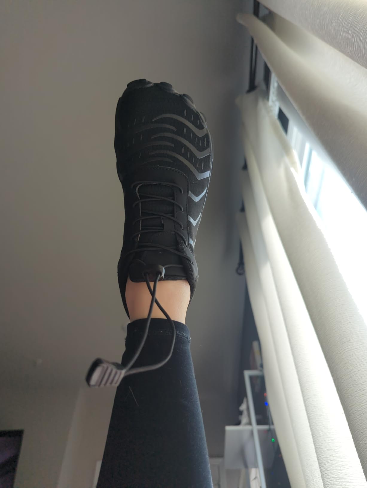 Barefoot shoes on feet showing natural toe spread and ground contact