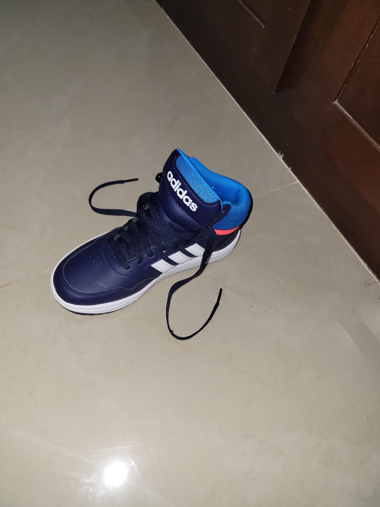 Action shot of Adidas Hoops 3.0 basketball shoes during recreational play showing court performance