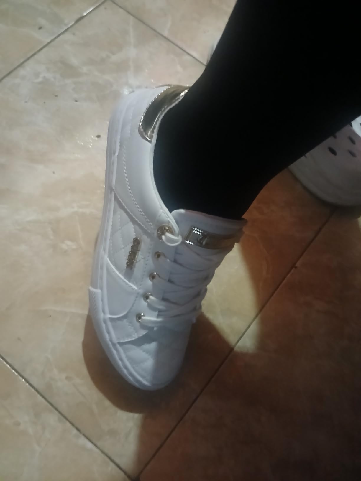 GUESS Women's Loven Sneaker detail shot showing logo hardware and quilted texture