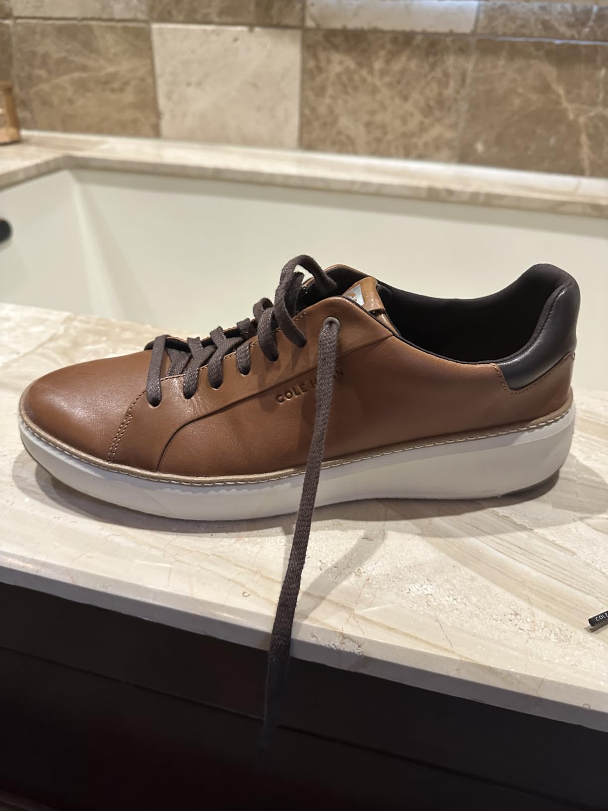 Multiple colorways of Cole Haan Grandpro Topspin showing different leather finishes and styling options