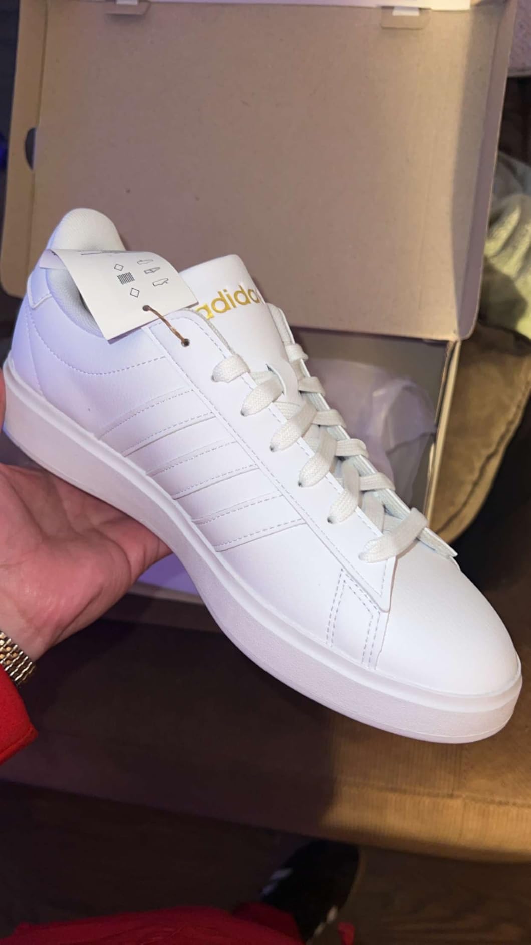 Close-up of Adidas Grand Court 2.0 showing lace-up closure system and padded tongue detail