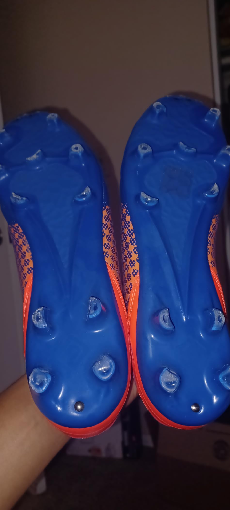 Detailed view of DREAM PAIRS cleat sole showing TPU stud configuration and wear pattern