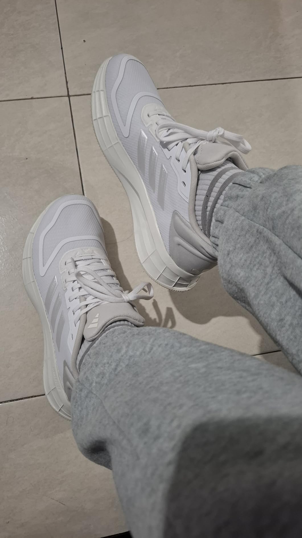 Close-up of Adidas Duramo SL 2.0 mesh upper construction showing breathable textile design and three stripes