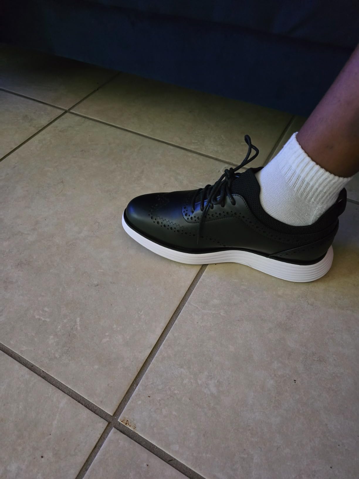 Side profile showing the casual sneaker sole with dress shoe upper design