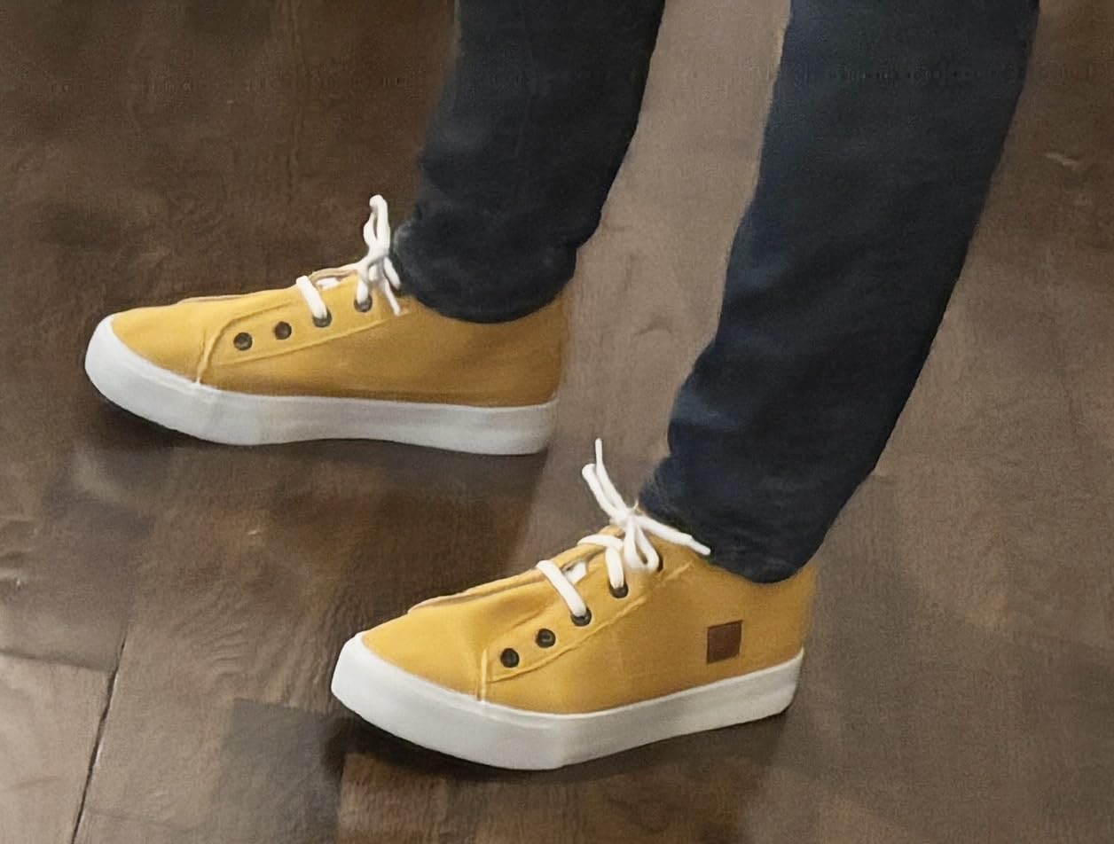 Side profile of XRH canvas sneakers showing elastic tongue mechanism and overall slip-on design functionality