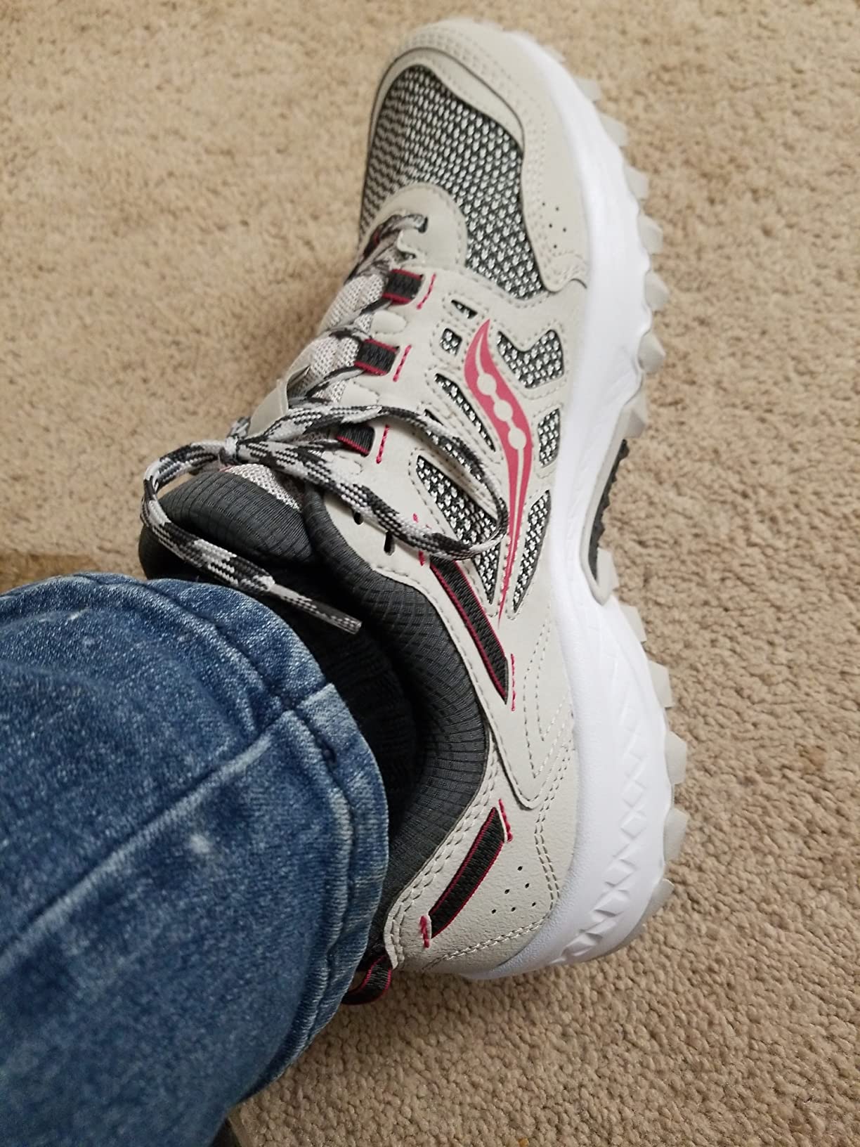Action shot of Saucony TR13 on natural trail terrain showing real-world usage