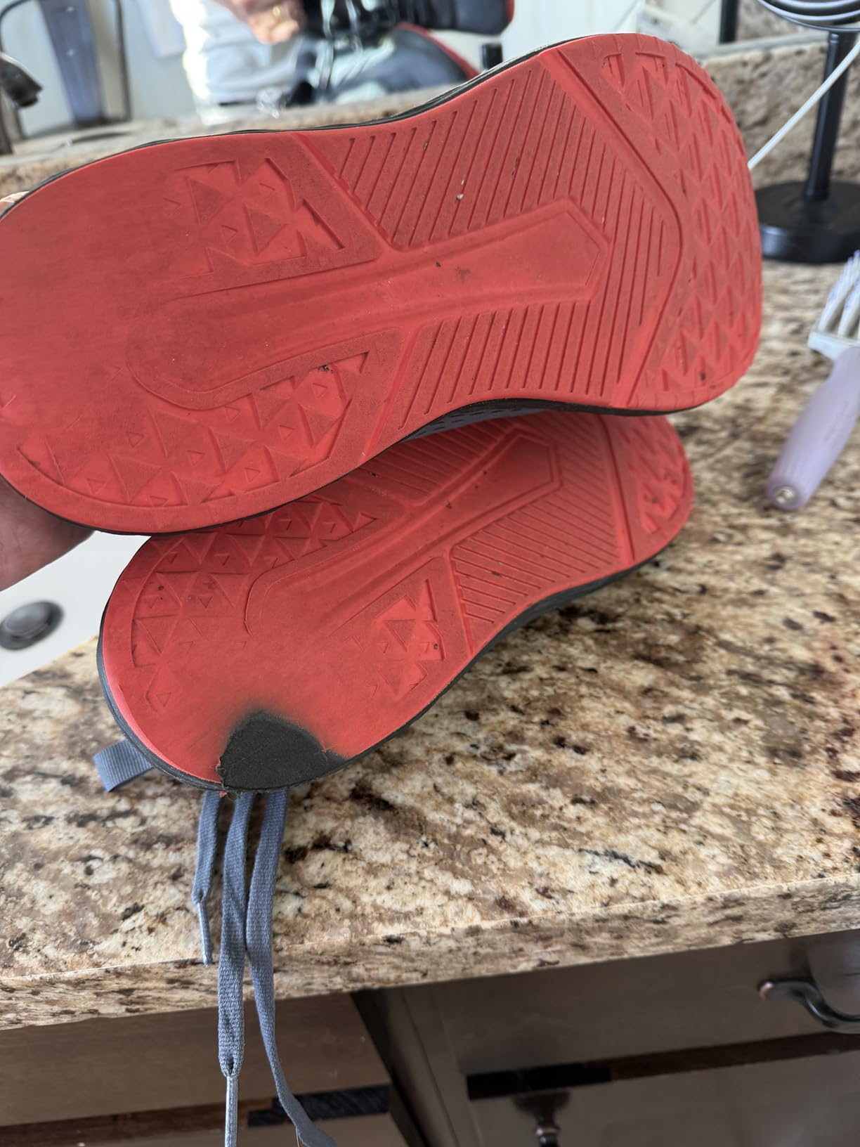 Worn WHITIN running shoe sole showing tread wear pattern after extended use