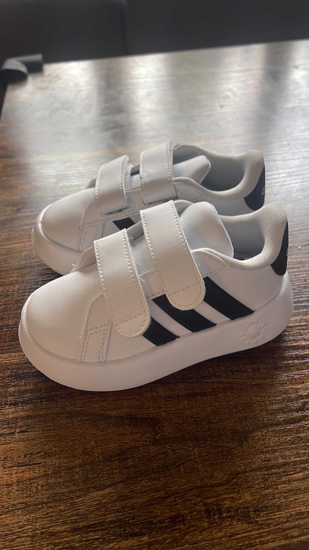 Kids wearing Adidas Grand Court 2.0 sneakers during active play showing traction and stability performance