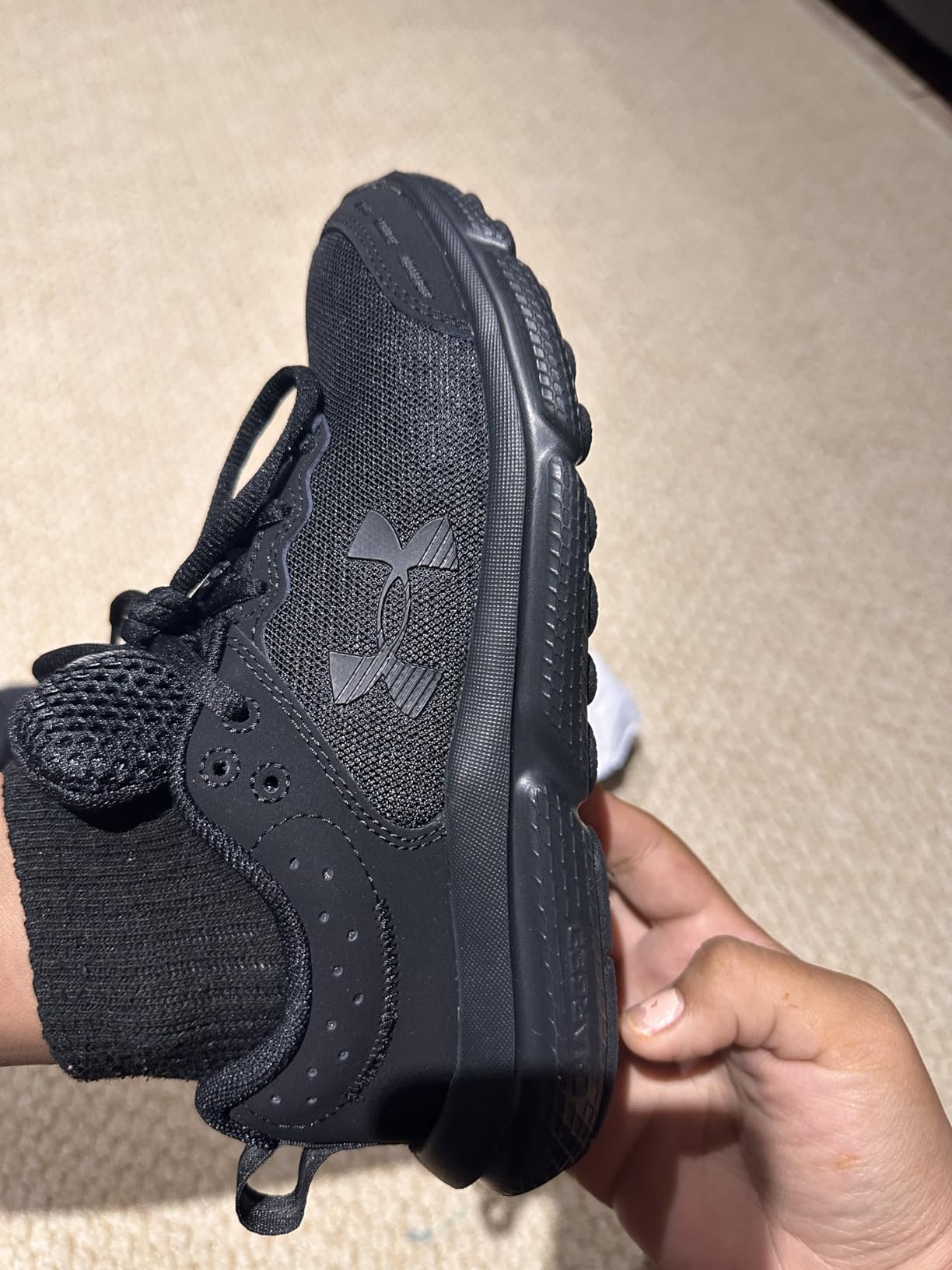 Under Armour Assert 10 in black and blue colorway showing style versatility