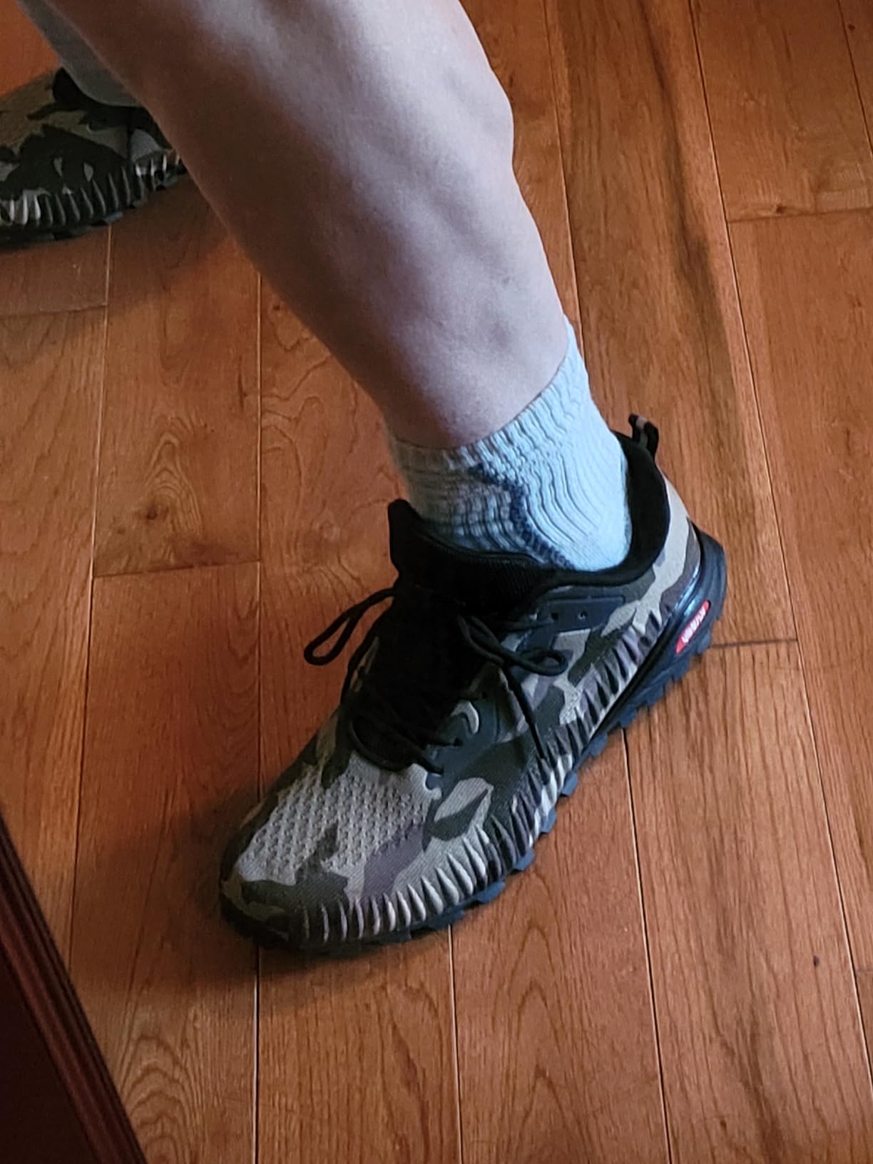 Bottom view of worn Kricely trail shoe showing tread pattern and durability after testing