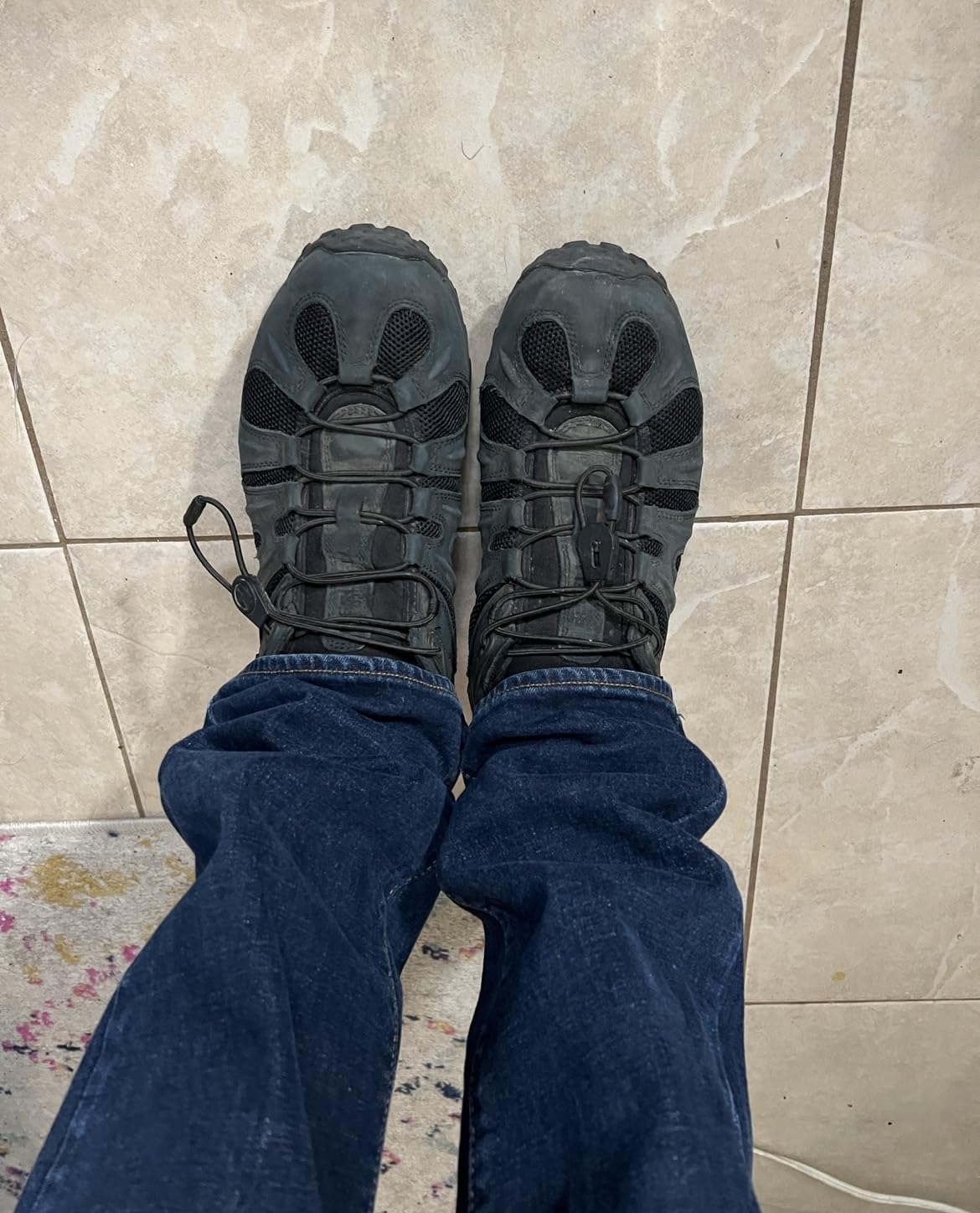 Action shot of Merrell Chameleon 8 during hiking showing ankle support and trail performance