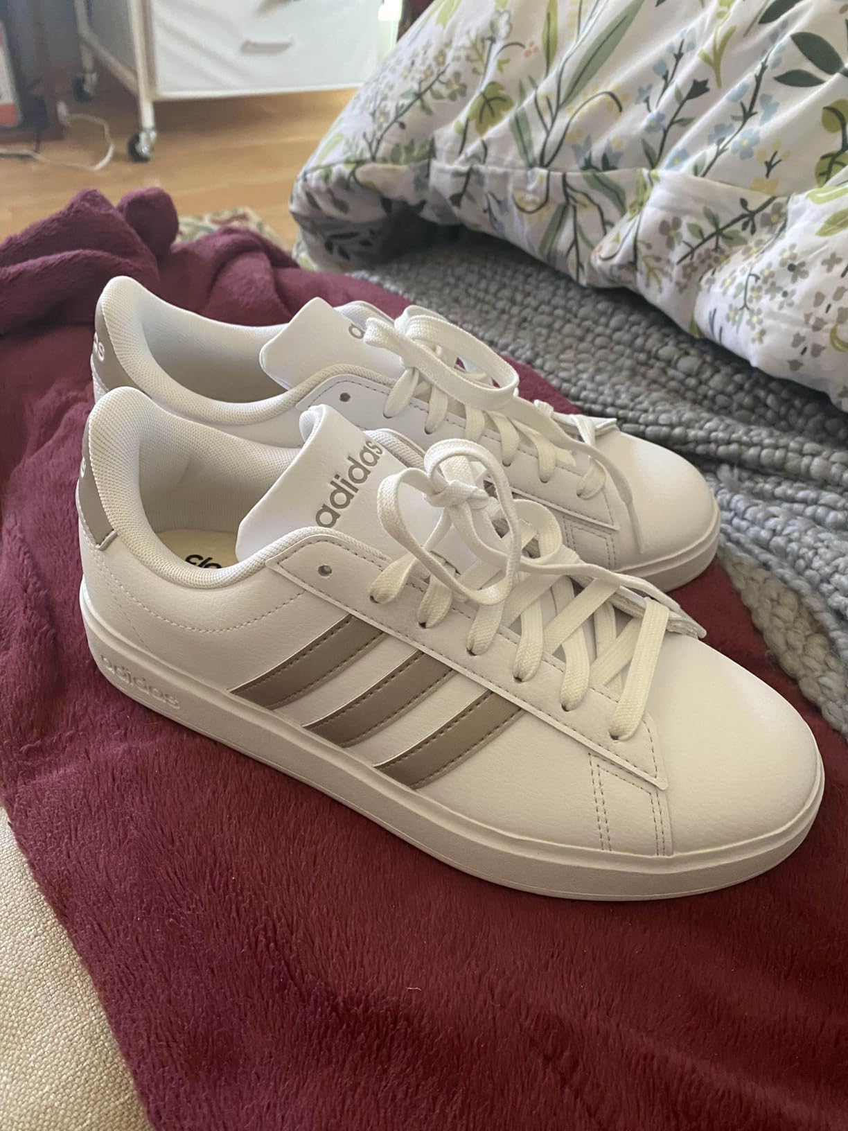 Adidas Grand Court 2.0 detail shot showing clean white leather construction and three stripes branding