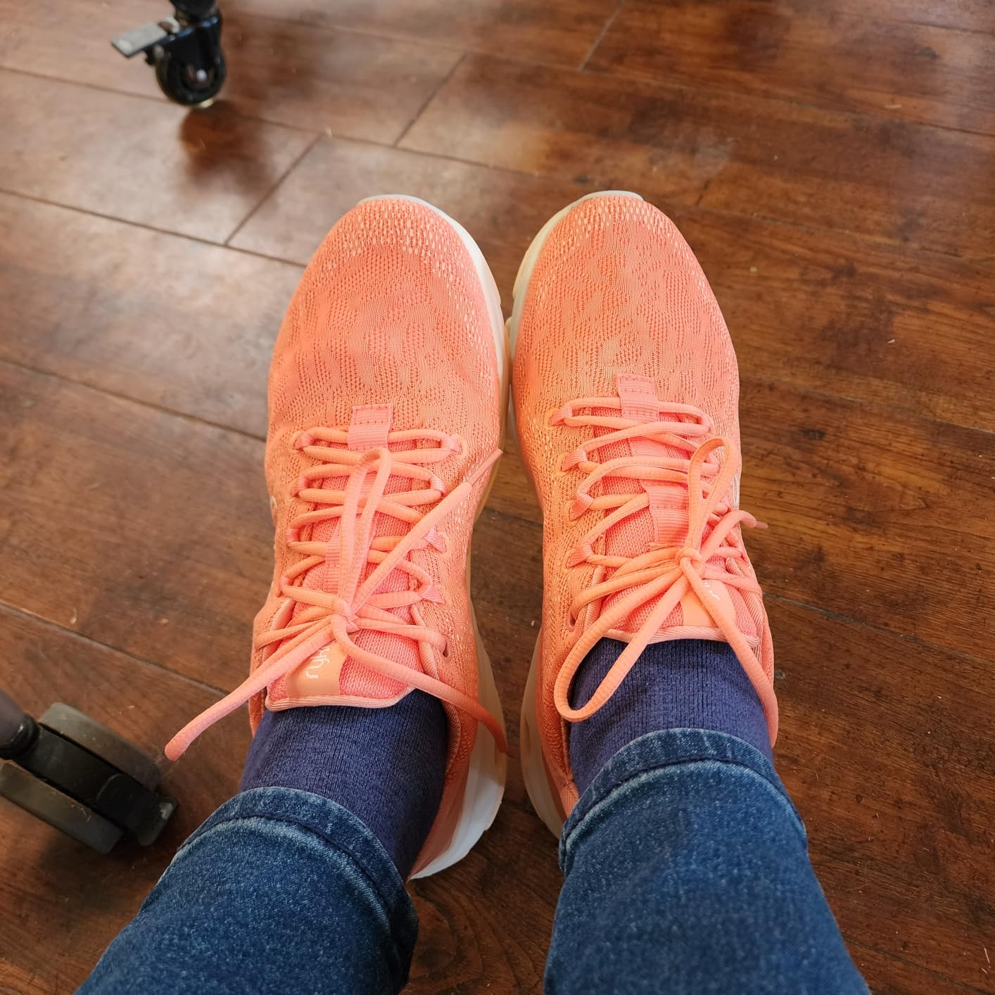 Ryka Devotion X in coral orange colorway showing feminine styling and support features