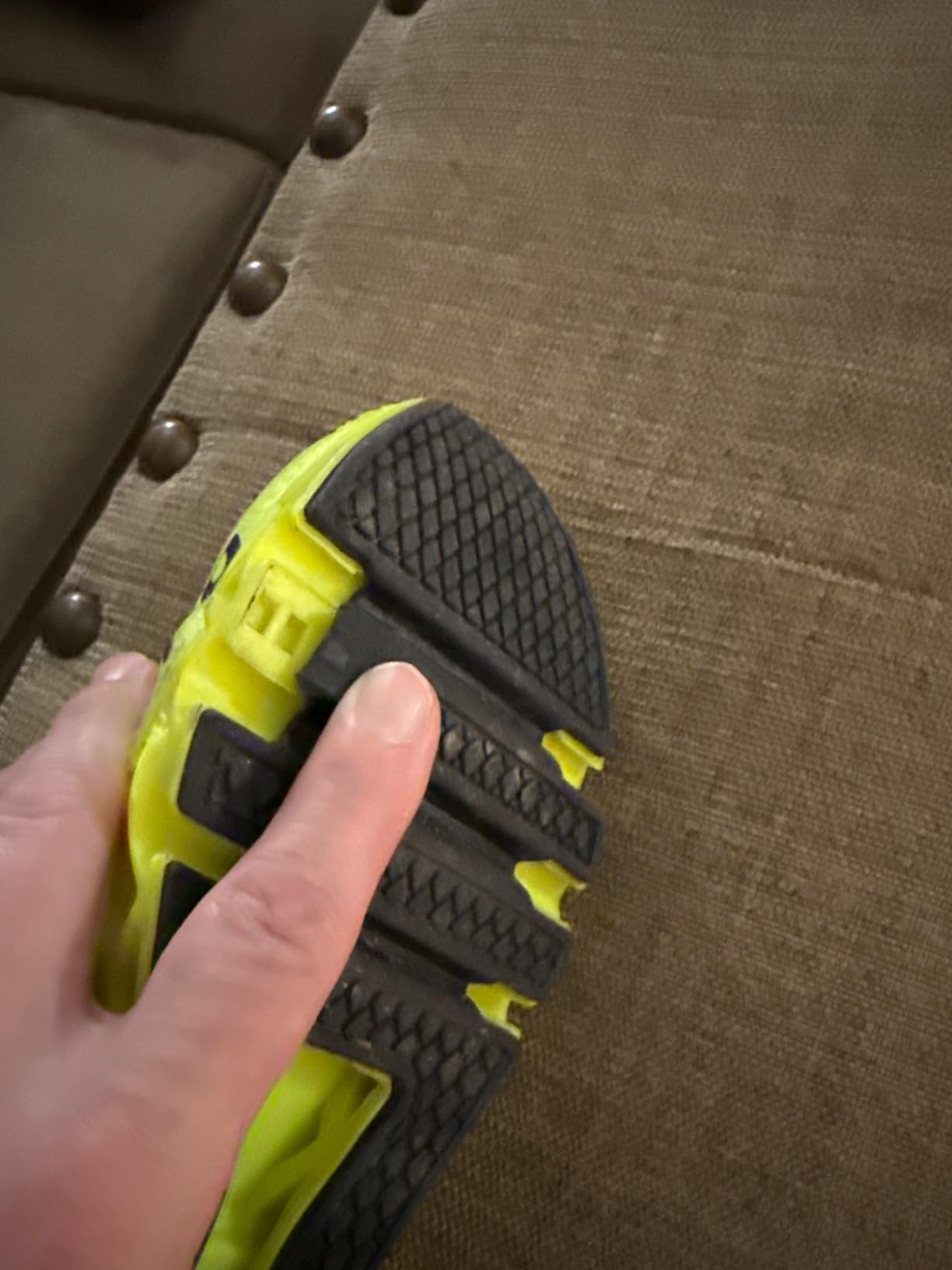 Close-up of sole separation showing rubber outsole detaching from shoe upper