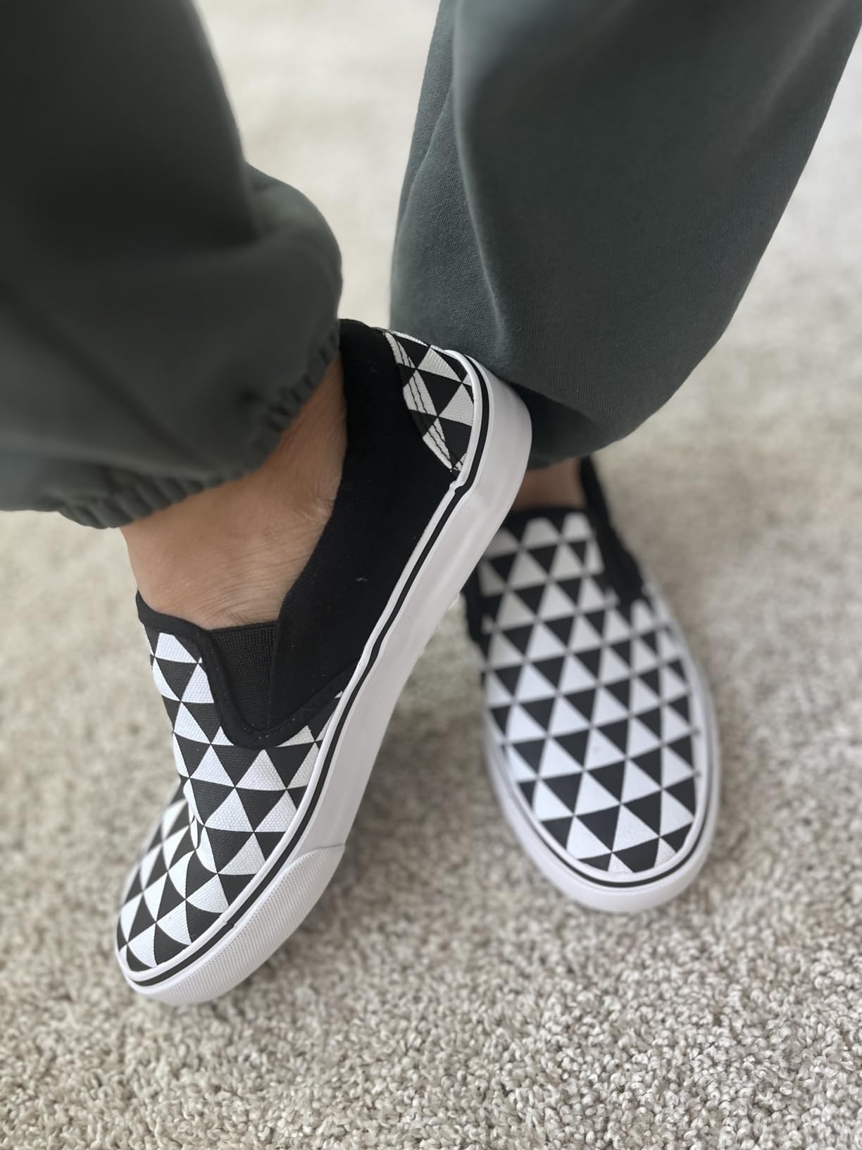 Close-up detail of canvas upper material and side elastic panels on women's slip-on sneakers