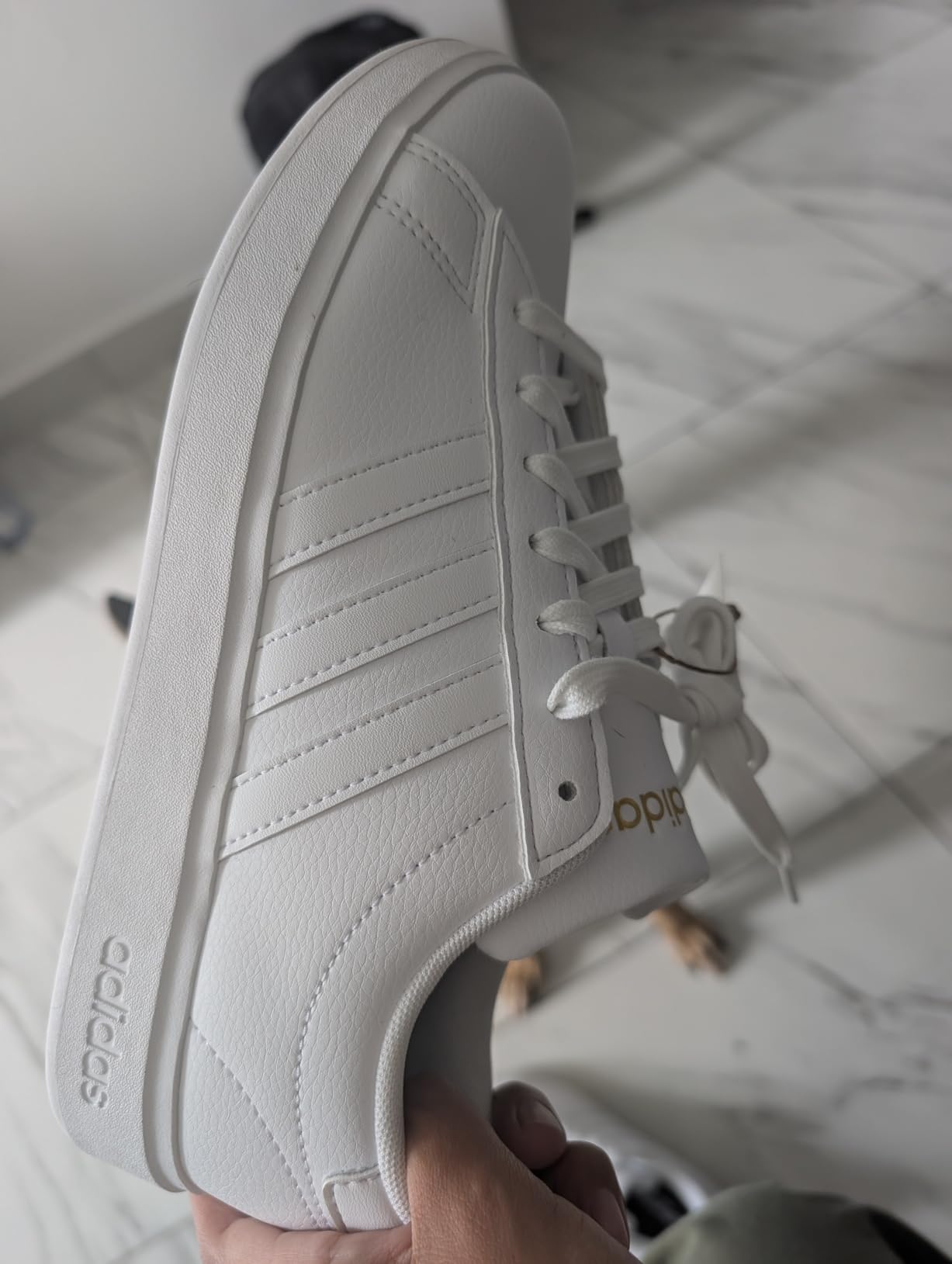 Adidas Grand Court 2.0 side profile showing synthetic leather upper construction and classic tennis shoe silhouette