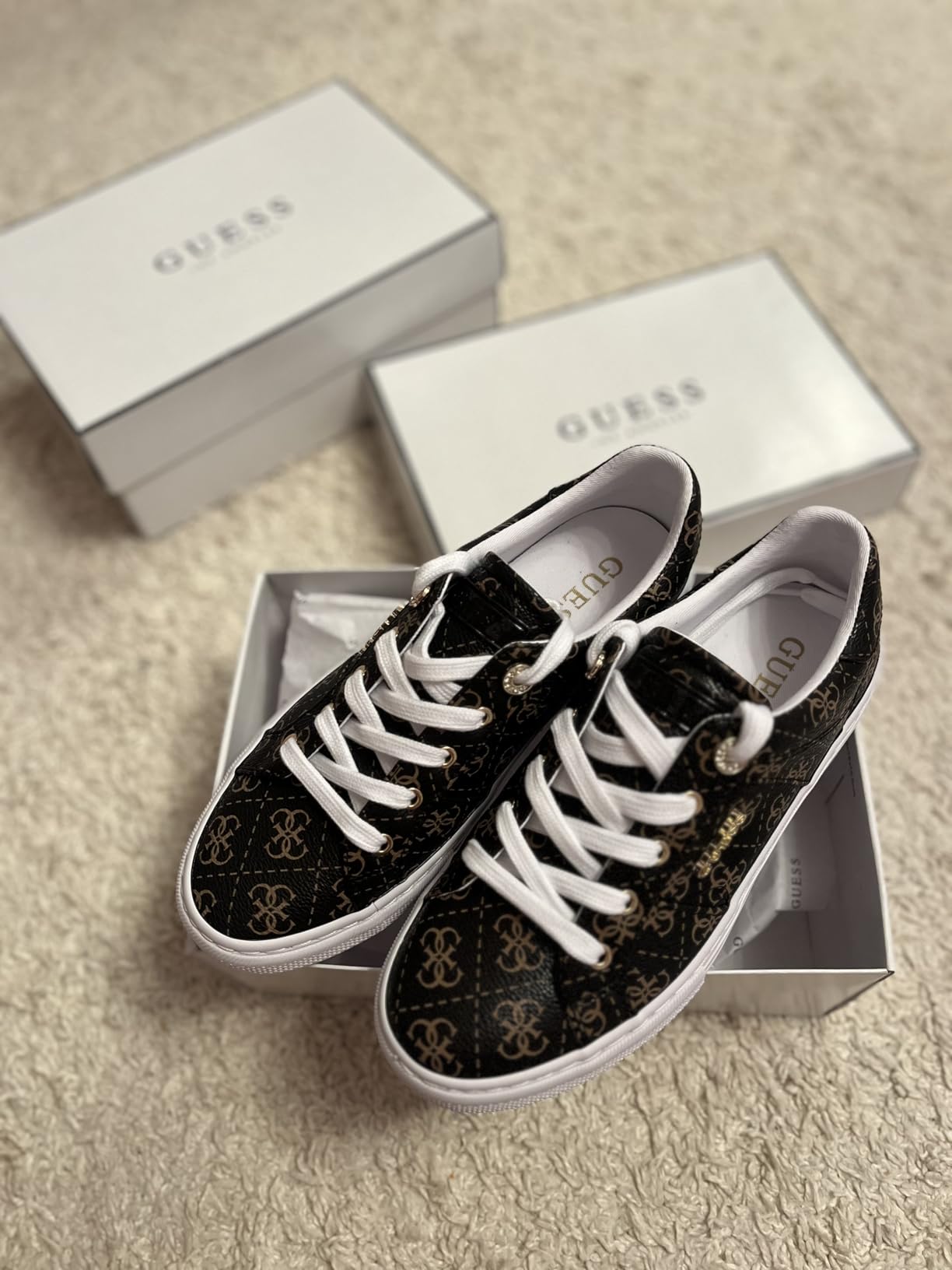 GUESS Women's Loven Sneaker worn with jeans showing versatile styling capability