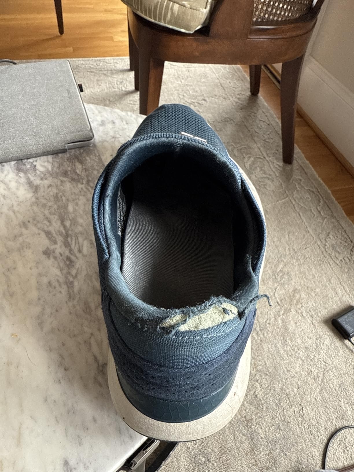 Evidence of heel wear after 6 months showing durability concerns