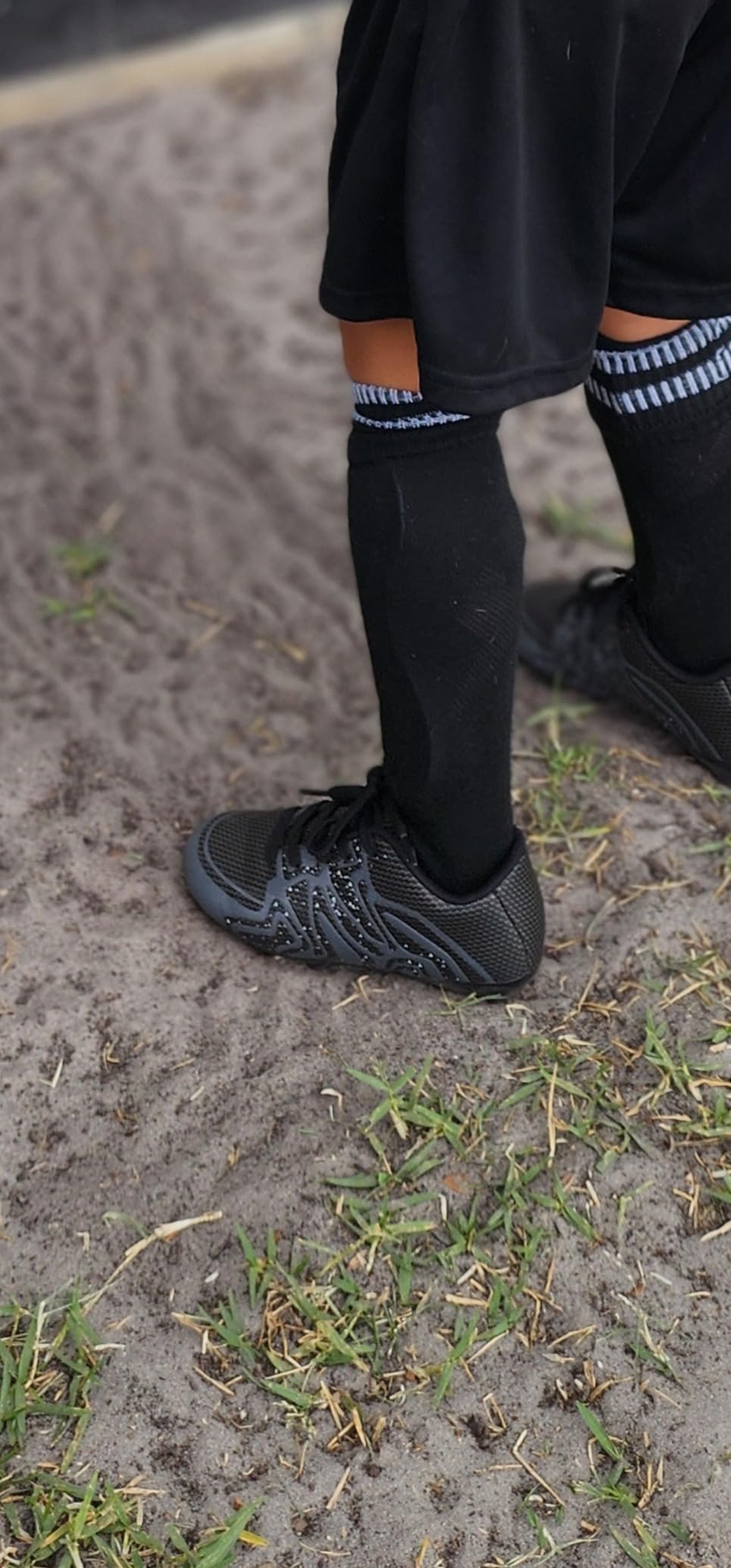 DREAM PAIRS youth soccer cleats being worn during actual game showing real-world performance and durability