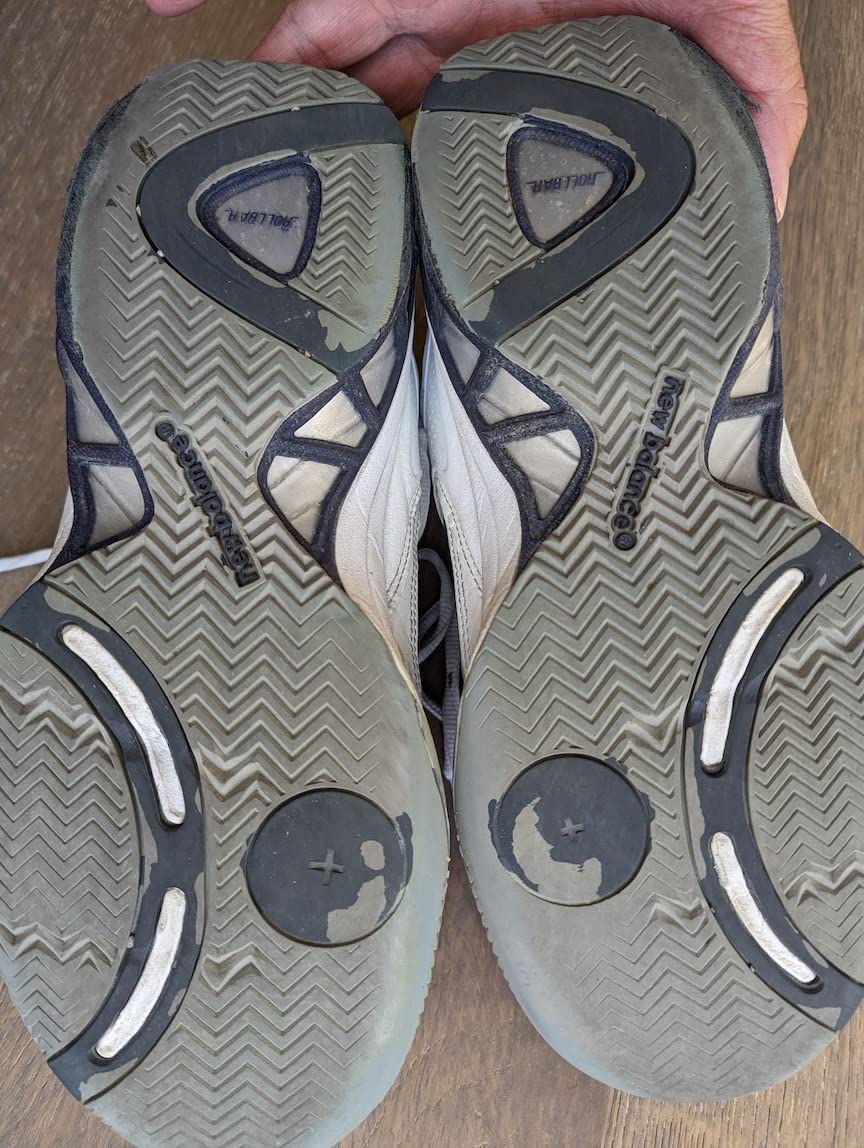 New Balance 806 tennis shoe side profile showing leather construction and support features
