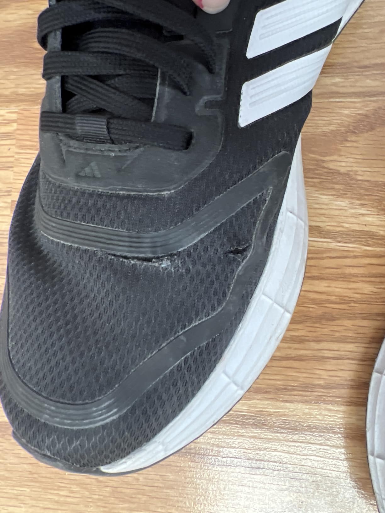 Detailed construction view of Adidas Duramo SL 2.0 showing quality control and build materials