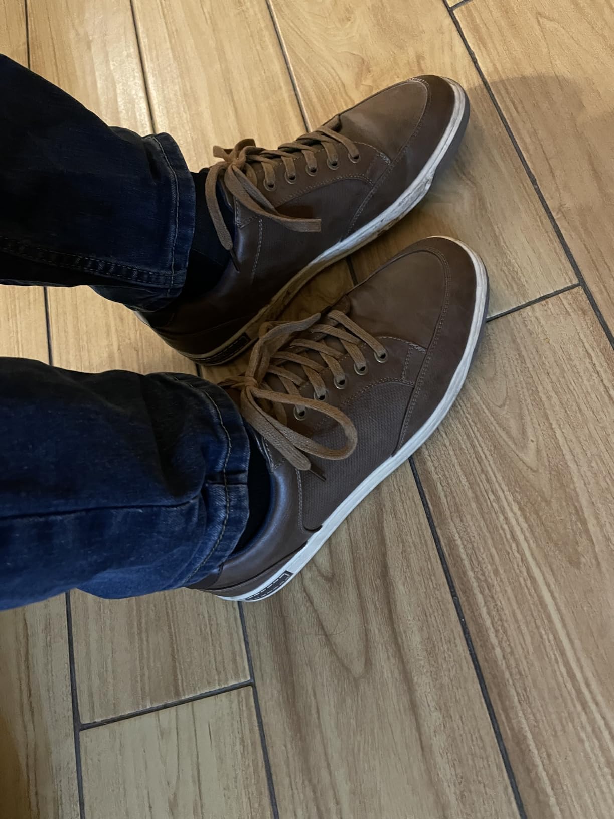 Close-up view of Jousen sneakers showing synthetic leather construction and perforated design details