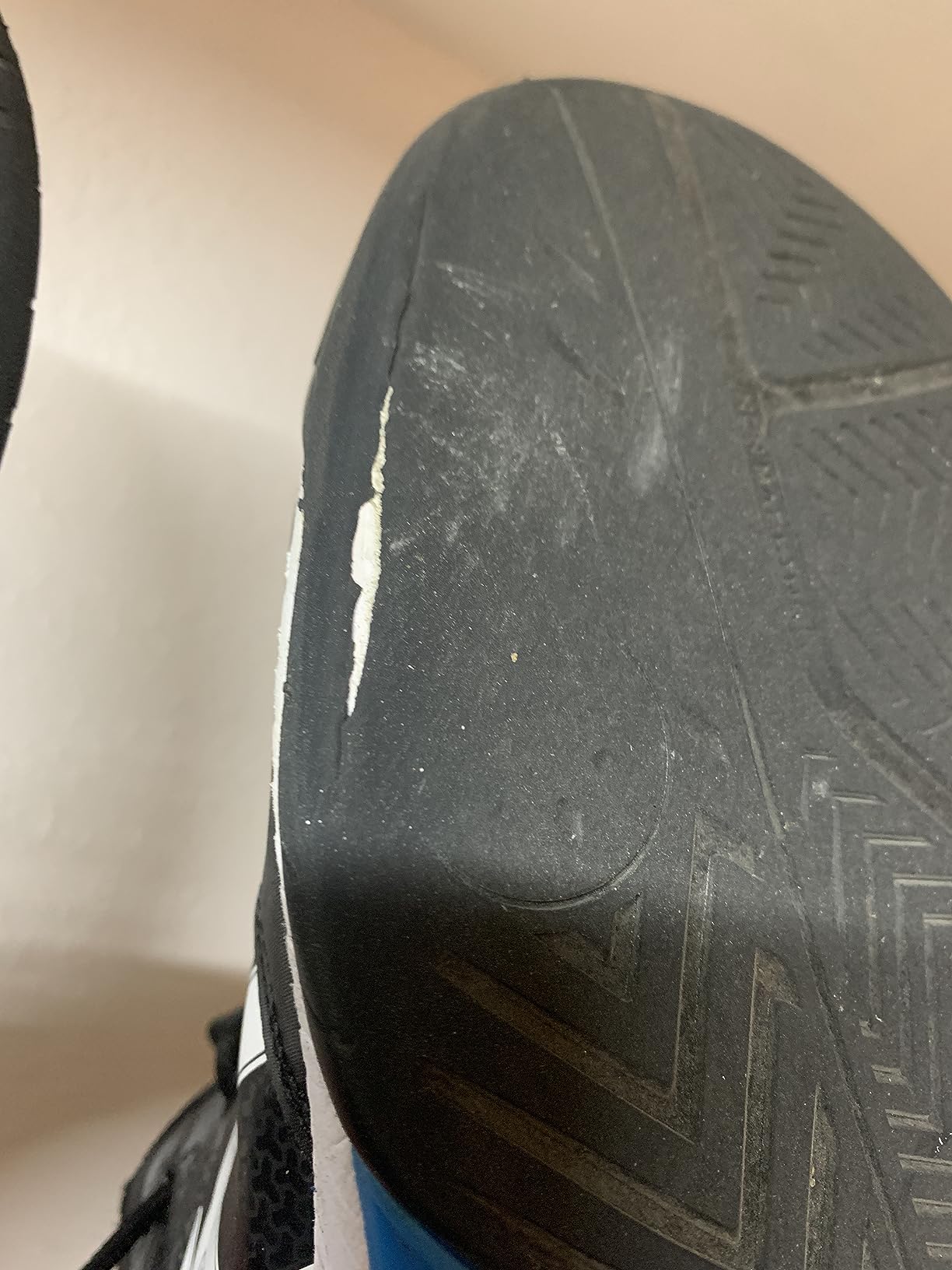Worn ASICS tennis shoe sole showing early wear patterns after court play