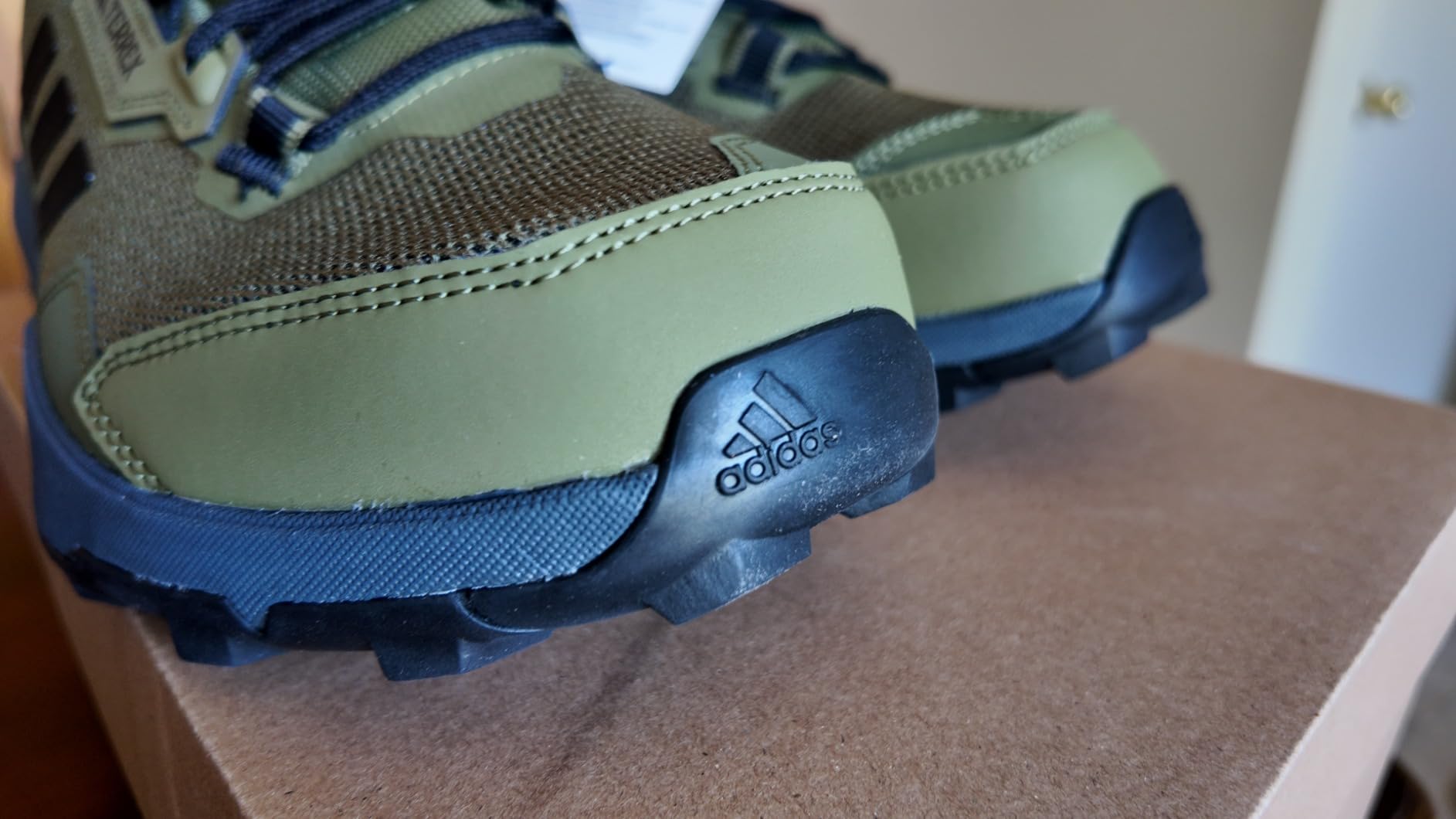 Adidas Terrex AX4 being tested on different trail surfaces including rocks and dirt paths