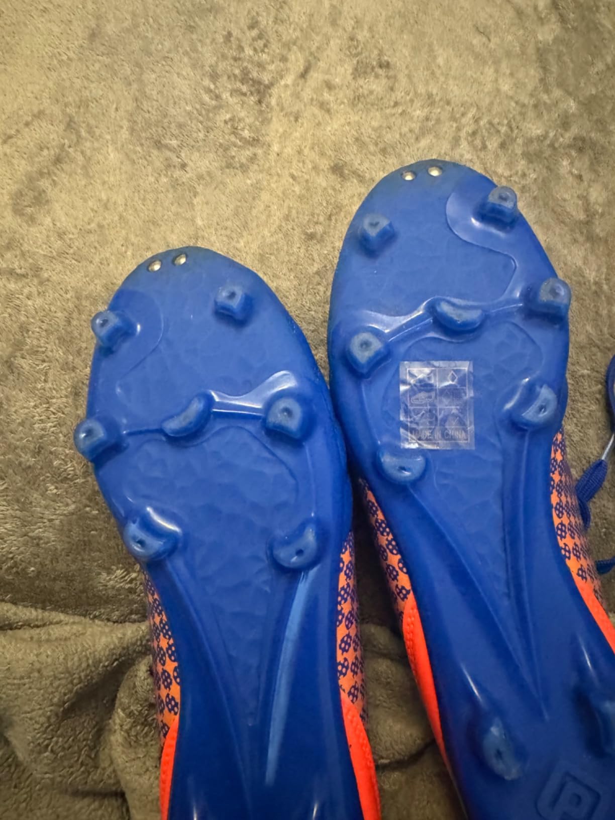 Close-up view of DREAM PAIRS cleats showing ball contact surface and lacing detail
