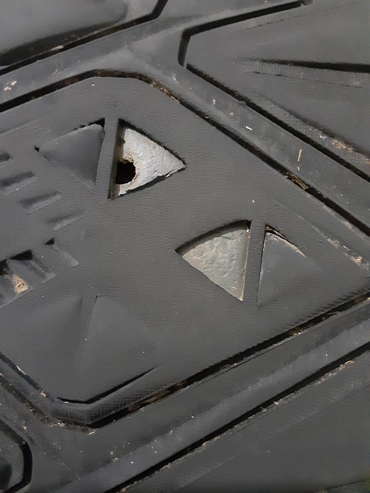 Bottom view showing aggressive tread pattern and rubber outsole design of Camel Crown shoes