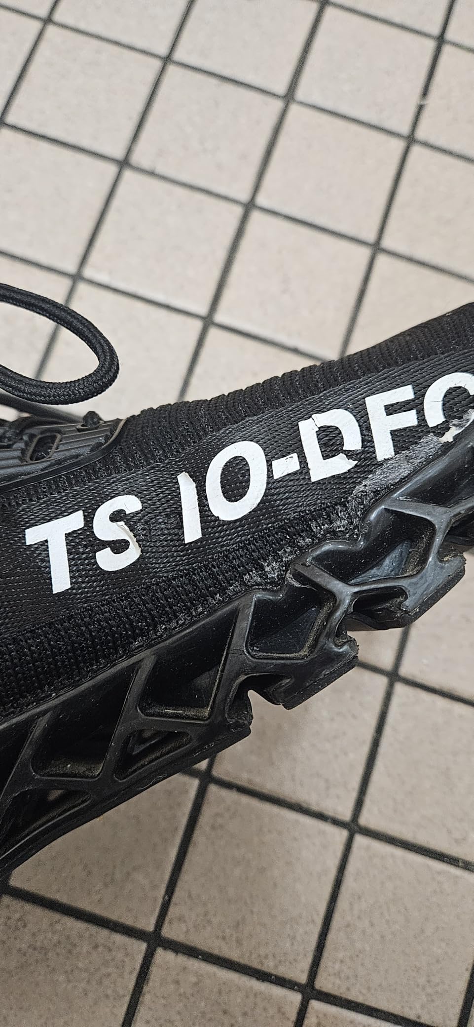 Close-up view of FRSHANIAH sneaker construction showing mesh upper and sole attachment quality