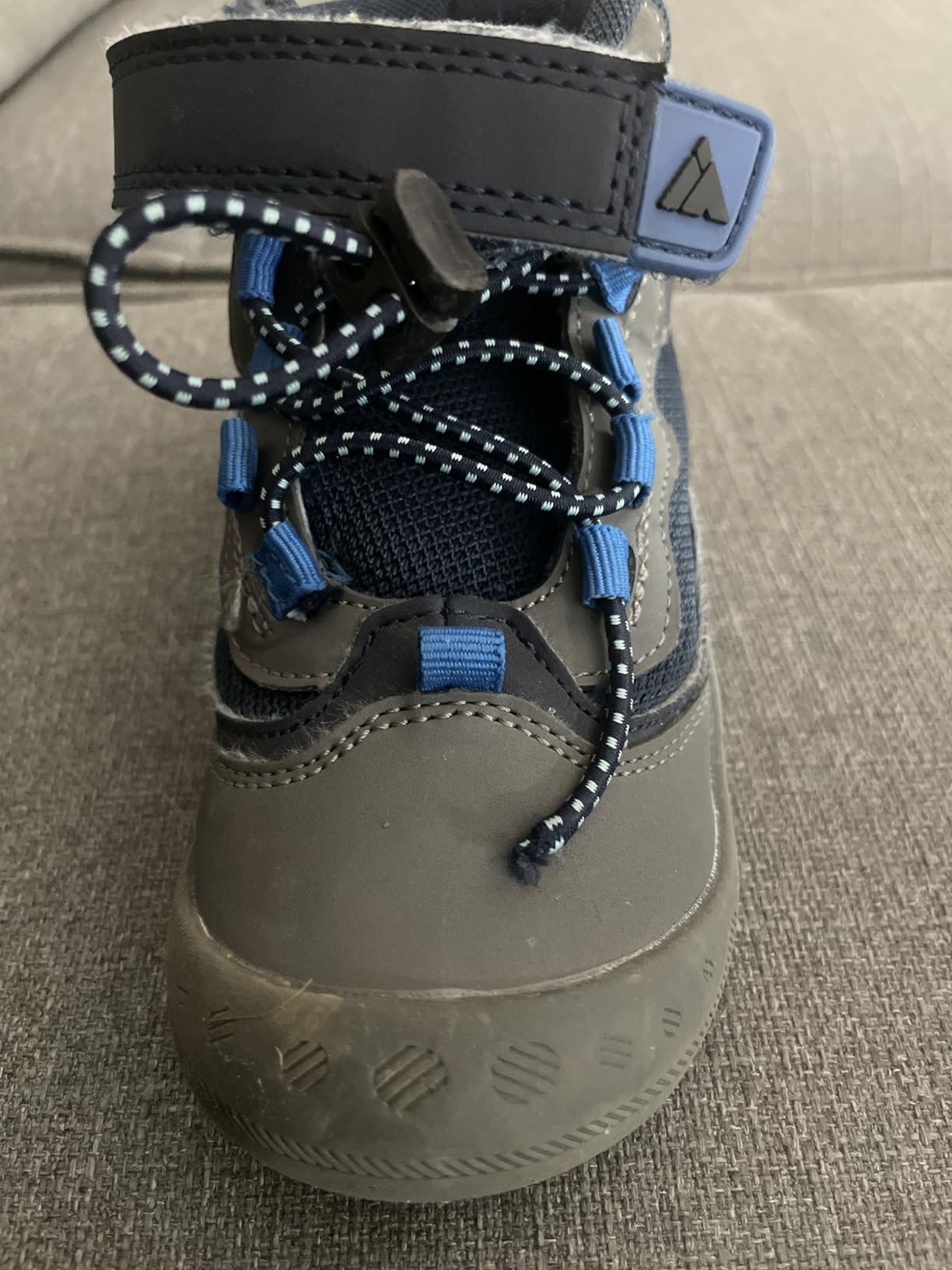Detailed view of Mishansha kids hiking boots closure system showing wear patterns after extended use