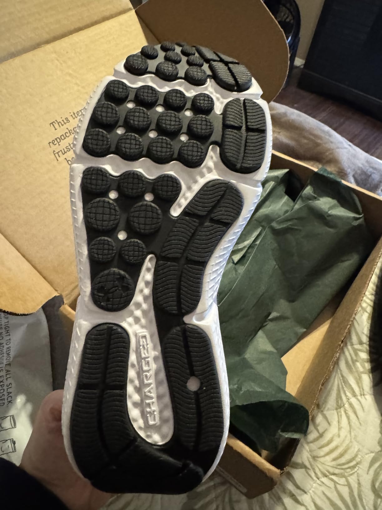 Side profile of Under Armour Assert 10 showing EVA midsole and heel support structure