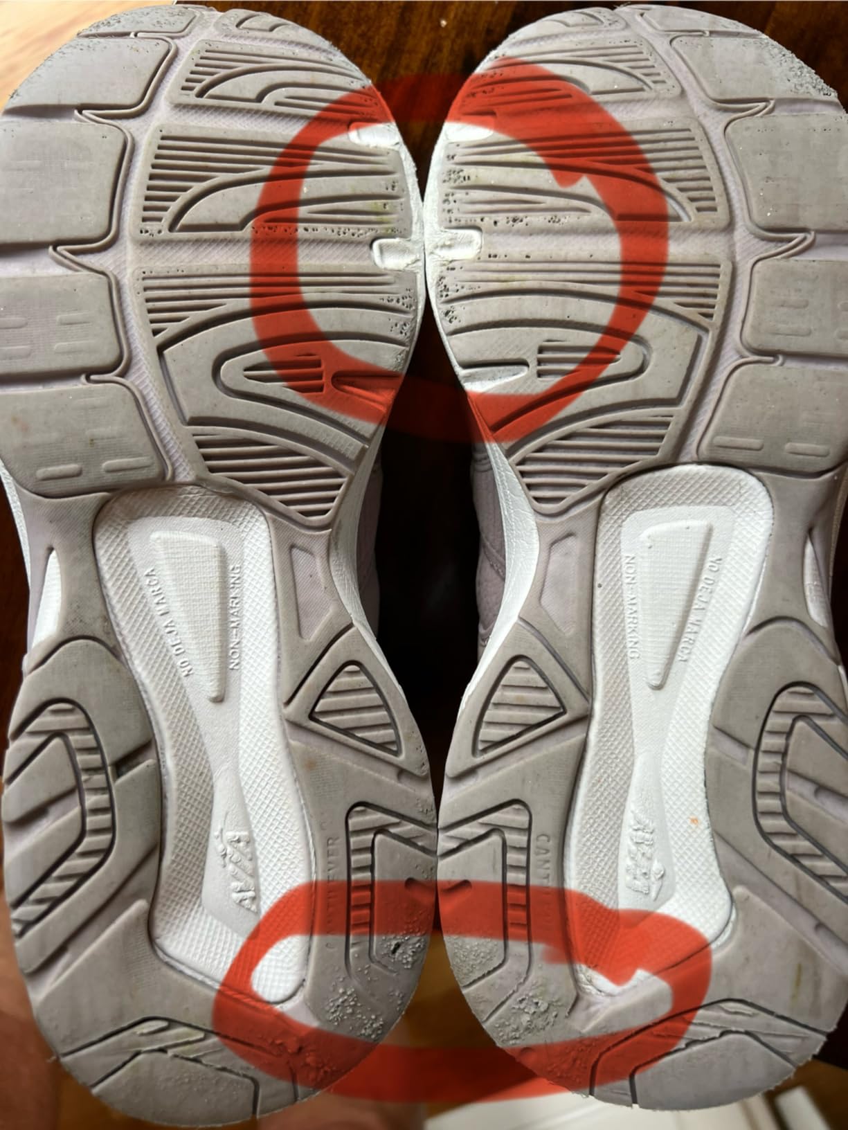 Close-up of sole wear showing exposed foam and deteriorated tread pattern after regular use
