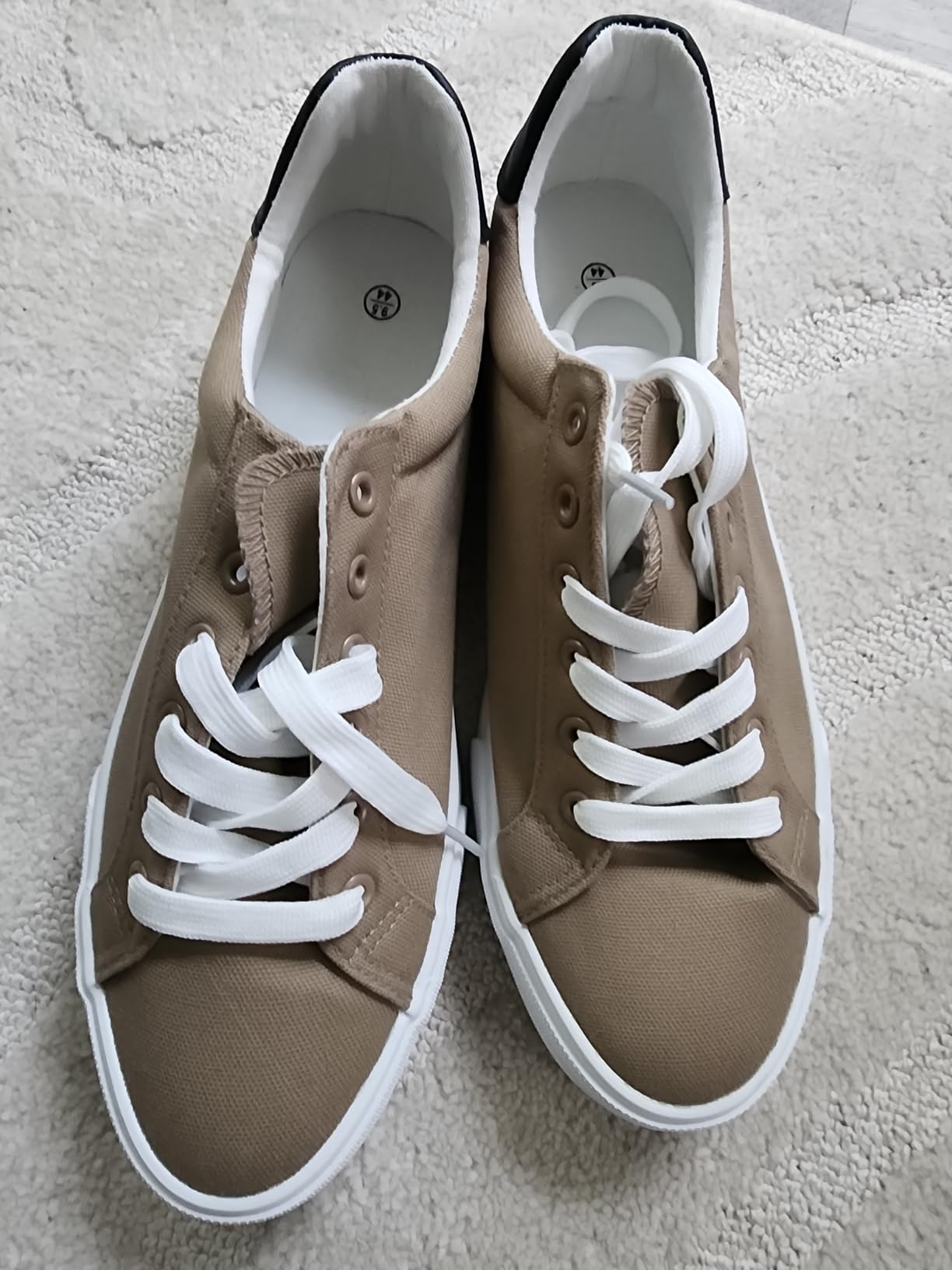 FRACORA white canvas shoes side profile showing low-top silhouette and minimal design