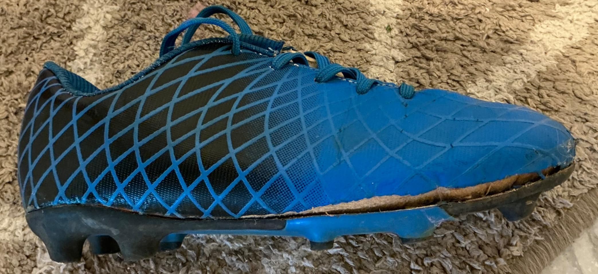 Side profile of JABASIC kids cleats highlighting the bright heel counter