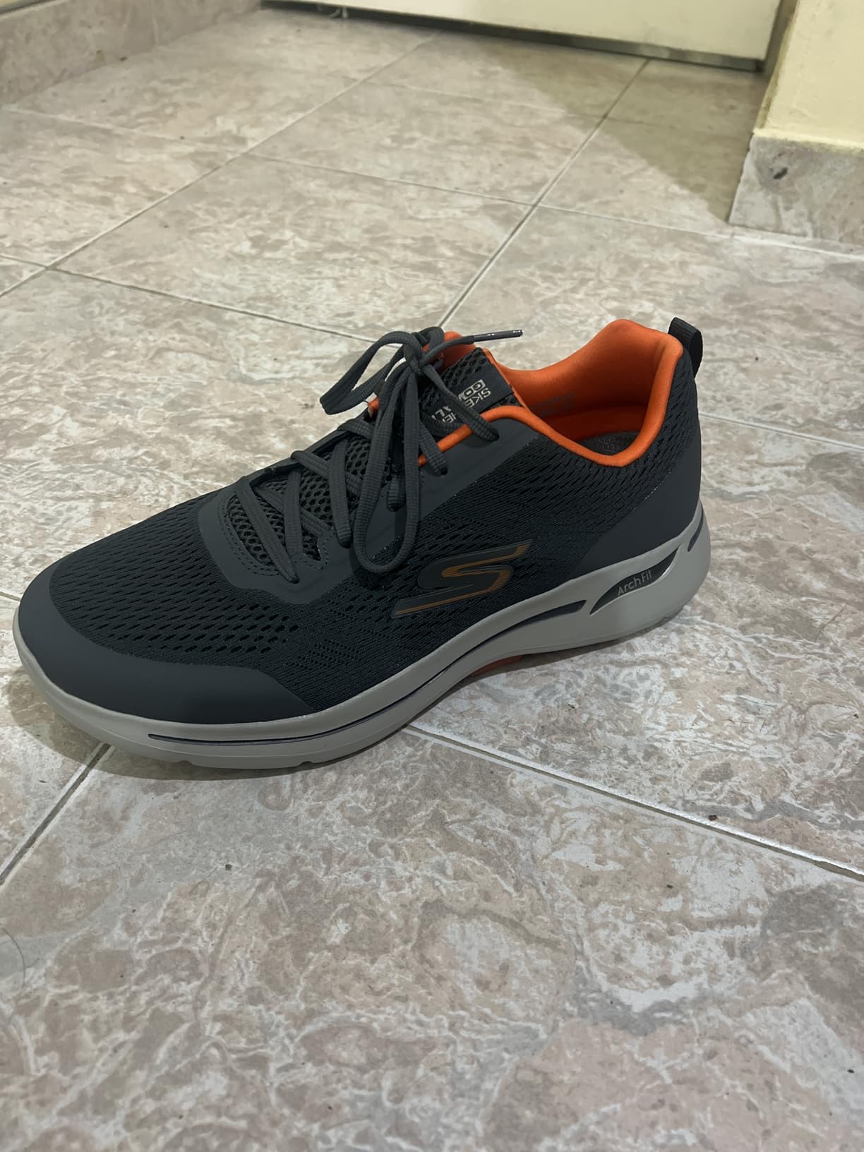 Close-up view of Skechers GoWalk Arch Fit mesh upper construction and lacing system