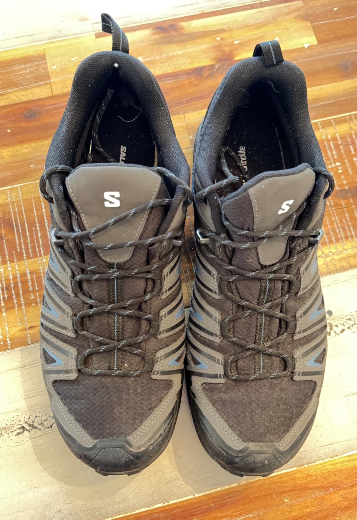 Multiple Salomon X Ultra Pioneer hiking shoes showing different wear patterns from real user experiences